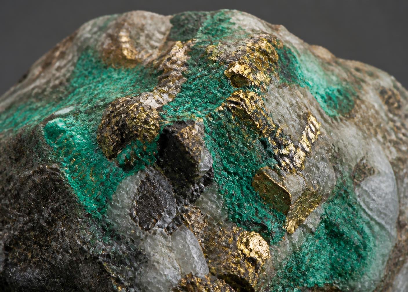 Copper-bearing rock with malachite staining and chalcopyrite